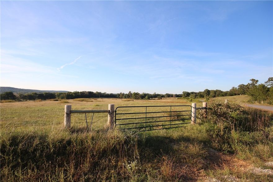 Incredible piece of land on the White River in prestigious residential growth area of Fayetteville. Endless investment potential. Beautiful potential home sites w/ views overlooking river bottom. Access to city water & utilities. 50/50 open/timber. Multiple access points off paved rd. Tillable production acres +pasture land & pond to support numerous cattle. Wire fencing & cross fencing. Recreational trail system. Great fishing, deer sign, natural vegetation, potential food plot sites. Boat ramp nearby.