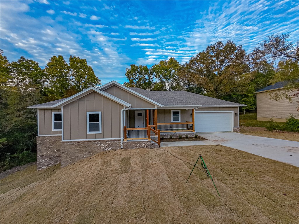 Just completed gorgeous 3 bedroom 2 bath house with all the bells and whistles. Enter your home from the inviting covered front porch into the open living room with electric fireplace and views to your private wooded backyard. Shaker white kitchen with 3 cm quartz counters, huge walk-in pantry. Covered private patio adjacent to dining area for enjoying the sounds of nature out back. Laundry room just steps from the kitchen has utility sink to help with those tough stains. Luxurious carpeted primary bedroom with relaxing free standing tub in master bath, tile shower and double vanities. 2 additional carpeted bedrooms with large secondary bathroom. Luxury vinyl plank flooring throughout main area. Home comes complete WITH GUTTERS and is ON SEWER. Walk-in crawlspace with high ceilings affords more storage area for sports and gardening equipment. Run, donāt walk, to this lovely new home on Chaucer!