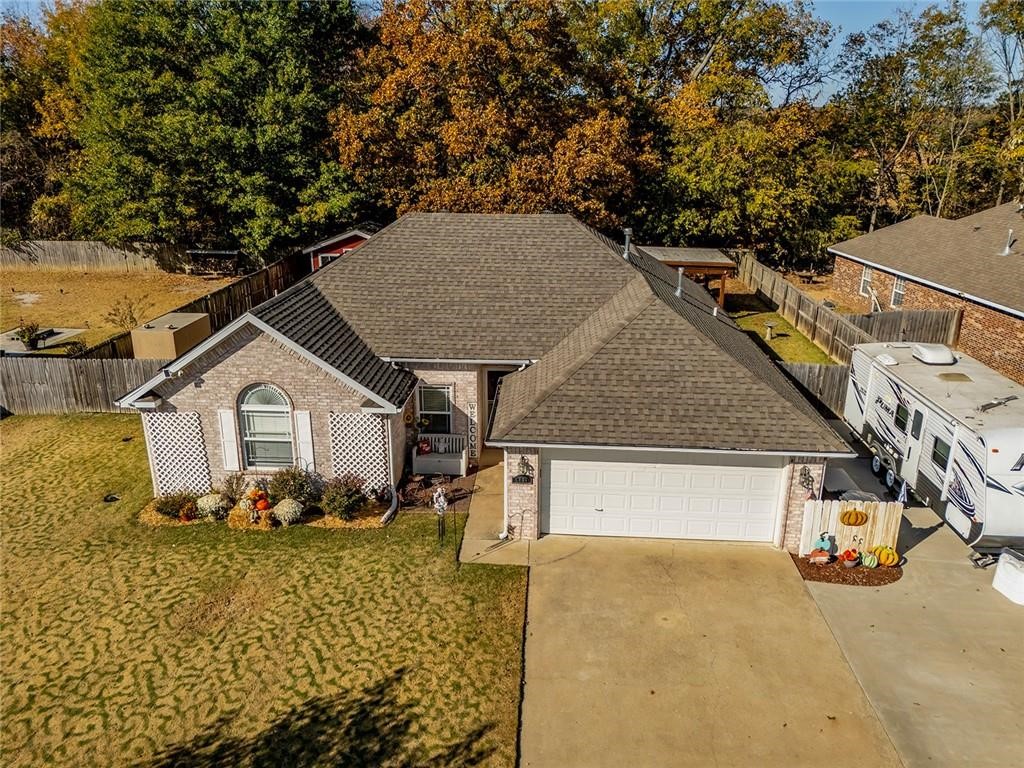 Beautifully updated 3 bed / 2 bath home packed with upgrades! Enjoy an open-concept layout with wood floors, a cathedral ceiling, and a cozy fireplace. The bright kitchen features white cabinets, granite counters, and a sunny dining nook. Relax in the sunroom or retreat to the spacious master suite with tray ceiling, walk-in closets, jetted tub, and separate shower. Energy-saving solar panels, a whole-home generator, storm shelter, and RV parking offer convenience and peace of mind. The fenced backyard includes a covered patio with concrete floor, gazebo, and large storage building—perfect for entertaining or hobbies. Fresh paint and new carpet make this home truly move-in ready. Just minutes from Fayetteville amenities. Call today to schedule your private tour!