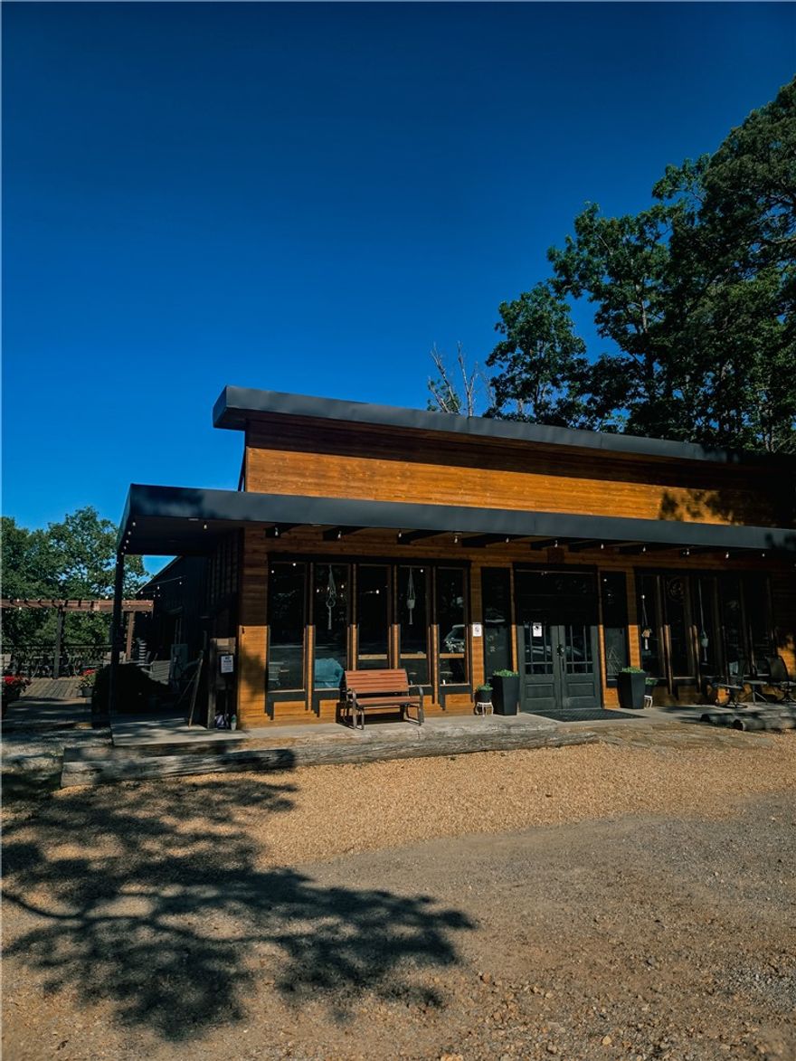 Exceptional commercial opportunity just 5 minutes from downtown Eureka Springs and only 1 mile from the Passion Play trails. This
15 ± acre property includes a 4,300 sq ft restaurant and event venue with full commercial kitchen, espresso bar, and large parking
area, plus a new luxury 2-bed/2-bath cabin in a serene, wooded setting. The venue is fully equipped for weddings, receptions, and
private events, featuring high-end finishes, indoor and outdoor seating, and a flexible layout for dining, catering, or retail concepts.
The cabin offers additional income potential as a nightly rental or on-site owner residence. While most of the acreage is forested,
approximately 5 acres are developed with utilities, road access, and space for light expansion. Zoned commercial, the property is
ideal for an operator or investor seeking a turnkey hospitality, restaurant, or mixed-use venture in one of Eureka Springs’ most desirable tourism corridors. Cross listed as residential. MLS 1329304
