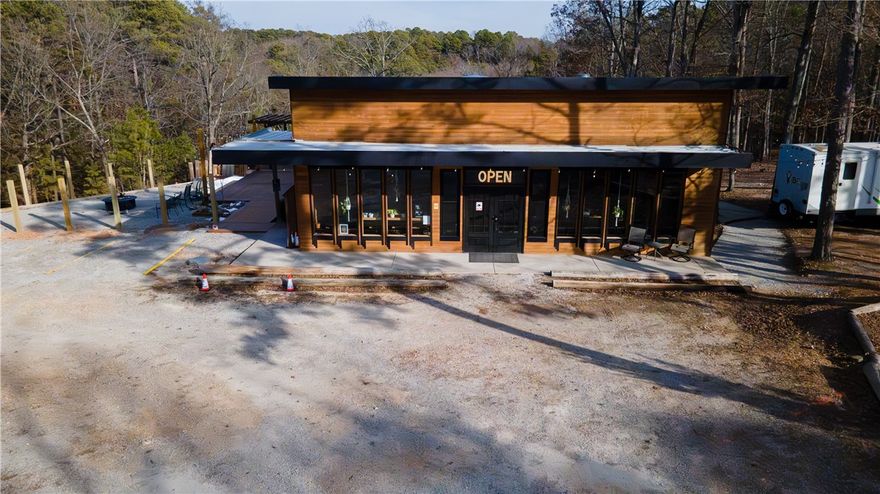 Exceptional commercial opportunity just 5 minutes from downtown Eureka Springs and only 1 mile from the Passion Play trails. This
15 ± acre property includes a 4,300 sq ft restaurant and event venue with full commercial kitchen, espresso bar, and large parking
area, plus a new luxury 2-bed/2-bath cabin in a serene, wooded setting. The venue is fully equipped for weddings, receptions, and
private events, featuring high-end finishes, indoor and outdoor seating, and a flexible layout for dining, catering, or retail concepts.
The cabin offers additional income potential as a nightly rental or on-site owner residence. While most of the acreage is forested,
approximately 5 acres are developed with utilities, road access, and space for light expansion. Zoned commercial, the property is
ideal for an operator or investor seeking a turnkey hospitality, restaurant, or mixed-use venture in one of Eureka Springs’ most desirable tourism corridors. Cross listed as residential. MLS 1329304