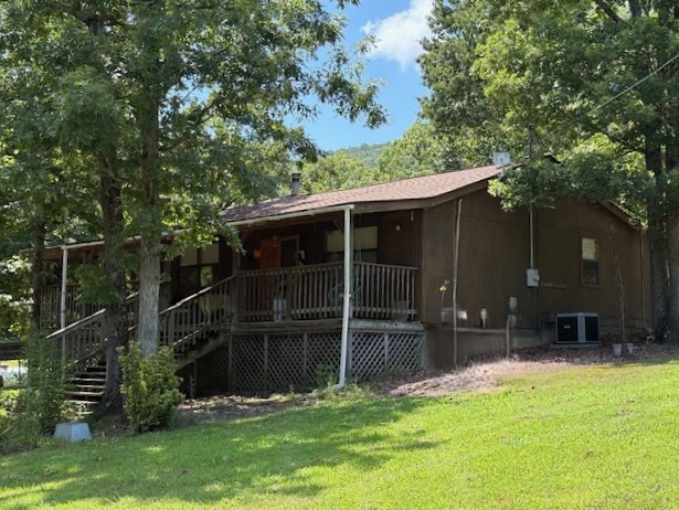 Discover the peace and privacy of the Ozarks with this rustic 3 bedroom 2 bath home set on 19 scenic acres. Surrounded by nature and offering mountain views and wildlife, this secluded property is perfect for a quiet county lifestyle with room to grow. The home features Central heat and air, plus wood burning stove and propane heater for backup heat, and the large covered front porch is ideal for enjoying the tranquil setting. The land includes a wet-weather creek, multiple outbuildings, a second homesite with water and septic, perfect for a cabin or mobile home, there's rural water on site plus two wells that are currently inactive. Whether you're starting a homestead, creating a family retreat, or investing in a getaway, this Ozark property offers comfort,utility, and natural beauty.