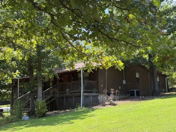 Discover the peace and privacy of the Ozarks with this rustic 3 bedroom 2 bath home set on 19 scenic acres. Surrounded by nature and offering mountain views and wildlife, this secluded property is perfect for a quiet county lifestyle with room to grow. The home features Central heat and air, plus wood burning stove and propane heater for backup heat, and the large covered front porch is ideal for enjoying the tranquil setting. The land includes a wet-weather creek, multiple outbuildings, a second homesite with water and septic, perfect for a cabin or mobile home, there's rural water on site plus two wells that are currently inactive. Whether you're starting a homestead, creating a family retreat, or investing in a getaway, this Ozark property offers comfort,utility, and natural beauty.