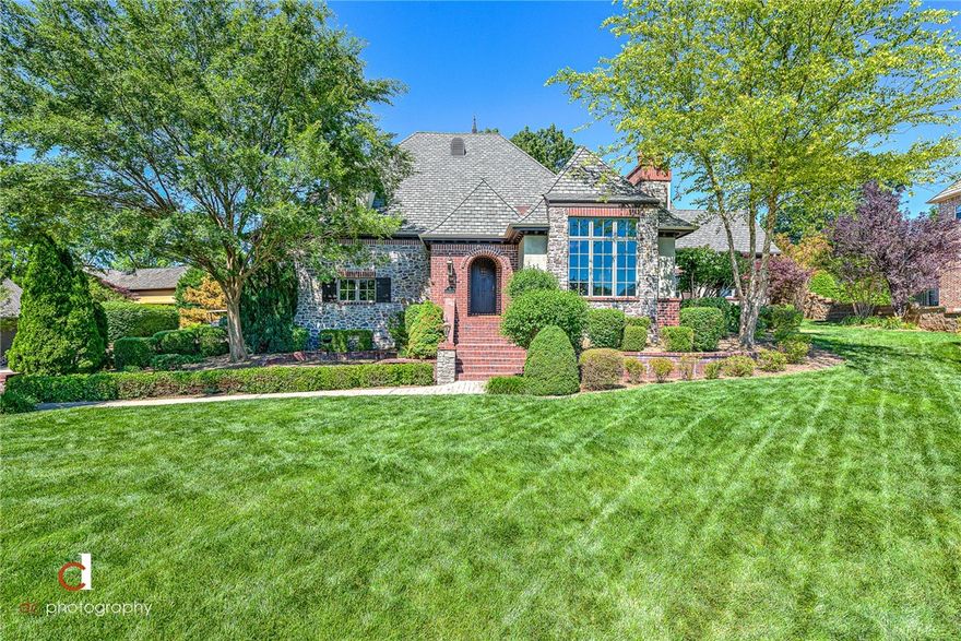 STUNNING CUSTOM-BUILT FRENCH COUNTRY MASTERPIECE NESTLED ON A ROLLING HILL IN THE PRESTIGIOUS PINNACLE COUNTRY CLUB CLOSE TO EVERYTHING NORTHWEST ARKANSAS HAS TO OFFER!  This beautiful setting offers an open floor plan ideal for entertaining and features a sprawling covered patio with meticulous backyard gardens.  Spacious and open gourmet kitchen w/ custom Verser cabinetry and Carrera marble countertops.  Beautiful hand textured walls surrounded by quality knotty alder/oak mill work throughout. Soaring stone wood burning fireplace, distressed beams with handmade corbels, beautiful oak flooring, cast stone fireplace and columns, oversized 3 car garage.  Within walking distance to the community pool and tennis courts!