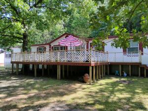 Peek at the LAKE in this 3 bedroom spacious home with 2 living areas. 3 bathrooms including a garden tub and a kitchen to love with it's open space and lots of cabinets. Wood burning fireplace, large closets, and a laundry room anyone will appreciate! Outside has room for many hobbies with a shop, shed, and a 5 lot wonderful yard.