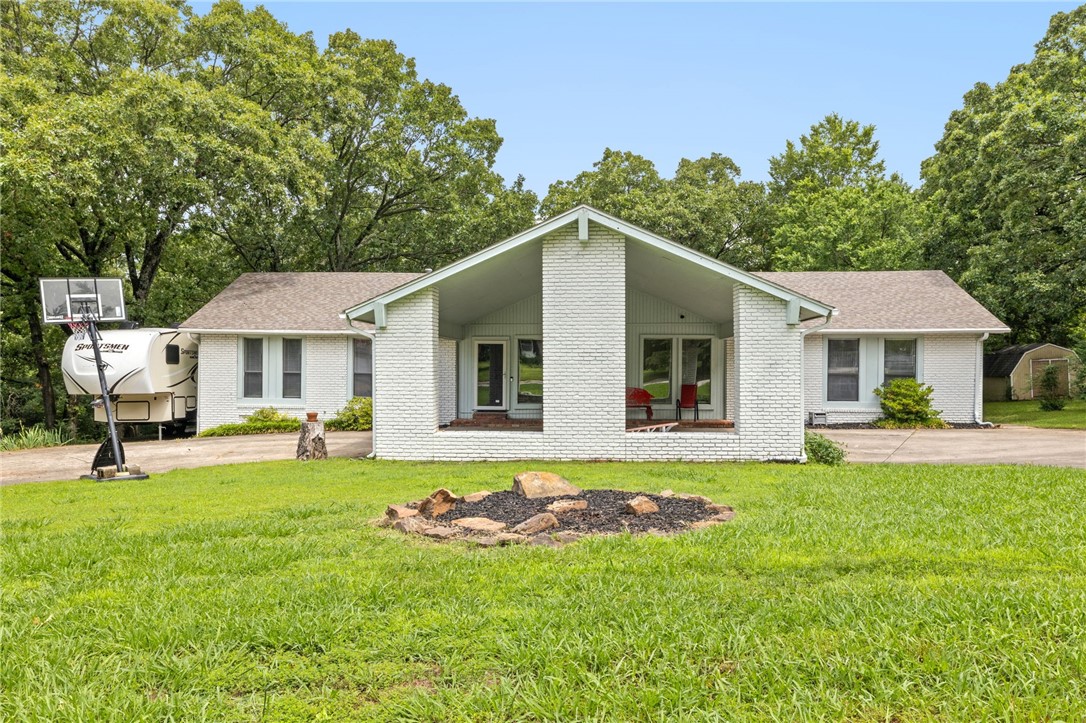 Live in the heart of Fayetteville, relax on your back porch overlooking a large lot with mature trees. This home has a split floor plan with 4 bedrooms and 3.5 baths, 2 large living rooms, or Bonus/Office space with additional exterior door. Location is close to shopping, schools, parks and the business district. Numerous updates including new flooring throughout (2019) roof and front gutters (2020) Bathroom and Kitchen remodel in 2020, wood burning fireplace 2022 and exterior Paint 2020. Additional parking pad will allow you to park your RV or Boat! Schedule your showing to see all this home has to offer!