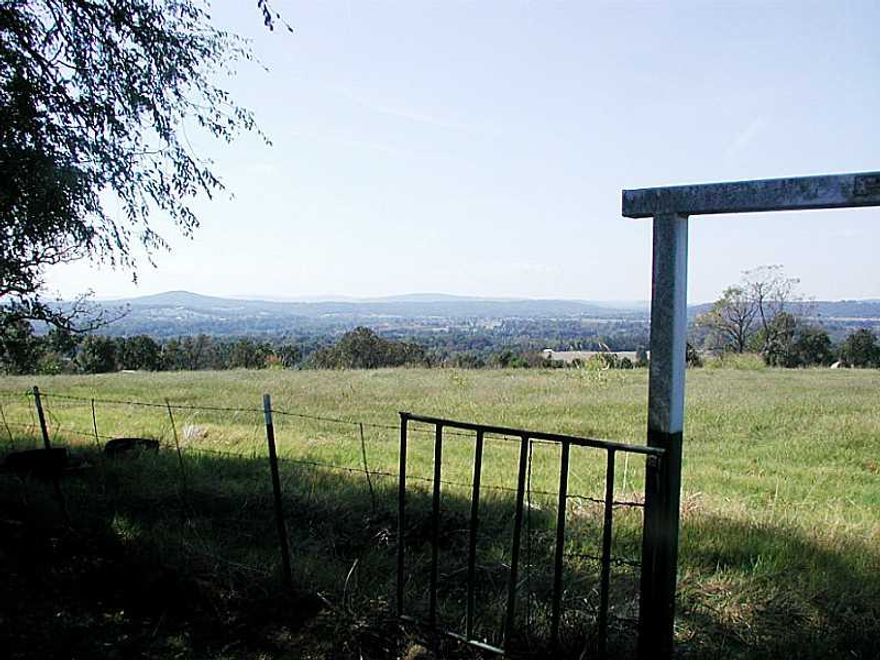 Beautiful farm with a million dollar view. Pastures with cross fencing, multiple ponds, 2 older houses, out buildings & shop/barn. 3,272 feet road frontage. Fayetteville schools. Value is in the land, property being sold "AS IS".