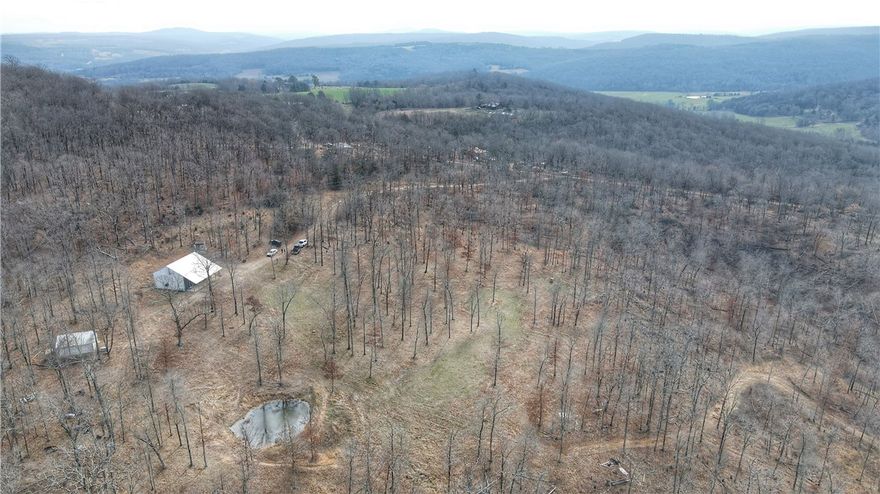 Tucked away in the scenic hills of Huntsville, this property offers a rare opportunity to own land rich in natural beauty and privacy in Madison County. The land is the true highlight, featuring expansive open areas and wooded sections that create a perfect balance of usability and seclusion. From multiple points on the property, you’ll enjoy stunning panoramic views of the surrounding Ozark hills, providing breathtaking sunrises, sunsets and year-round scenery.
A creek winds through the property. With plenty of acreage and maintained trails to explore, the property is ideal for those wanting space for a farm, recreation, hunting or room to roam. Additional building sites could easily be developed while still maintaining privacy and charm.
Conveniently located just a short drive from Huntsville and reasonable distance of Fayetteville, offering the best of rural living with access to all of NWA. Whether you’re looking for a full-time residence, weekend escape or investment in the Ozarks, this property has it.