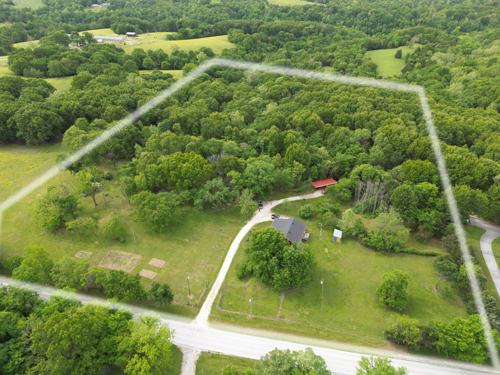 Two homes, endless options. This fully fenced property offers a finished 1,200 sq ft main house just a few years old, plus a second 600 sq ft structure ready for your personal touch. The second home has the shell in place—framed, insulated, with plumbing and electrical roughed in—giving you a head start to finish it your way. Each home has its own electric meter and septic system, making it ideal for guests, extended family, or rental potential. There are several peach, apple, and persimmon trees. As well as a ton of blackberry and raspberry bushes. The land is partially cleared for usable space while still offering wooded privacy. A great setup for someone looking to create their own space while living on-site.