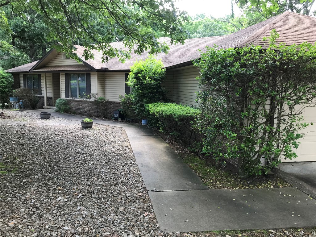 Single level, 3 bedroom, 2 bath, 1-owner ranch on a corner lot and quiet street with a sideload garage and level driveway in the heart of Bella Vista! Very close to Beach at Lake Avalon and near trails, Tanyard Creek, Lake Windsor and Loch Lomond! Well kept, split bedroom plan with low maintenance brick and vinyl siding exterior and gutter guards. Oversized (deep) garage great for boat trailer, golf cart or shop. Wood burning fireplace, sunroom and open rear deck with wooded view make for great entertaining options. Eat-in kitchen with solid oak cabinets, Silestone counters and good storage throughout. New portable gas generator and refrigerator convey and house wired for quick generator connect. Sewer connection upon sale! Owner has moved, selling as is, act now for quick possession and make it yours! Open house Sunday, June 27, 1-3 PM.