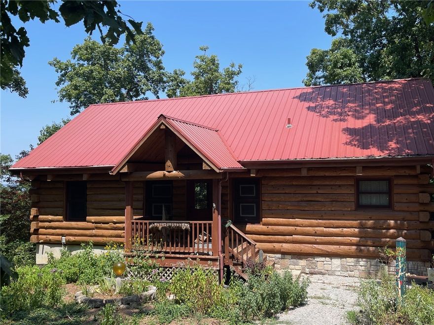 Charming Country Retreat with Modern Comforts!
Welcome to your dream home nestled in the heart of serene countryside living! This beautiful 3-bedroom, 2-bathroom log home sits on 14 acres m/l with mature trees, open skies, and room to breathe.
   •   Inviting Front Porch – Perfect for morning coffee or evening relaxation with a custom built waterfall running through the natural bluff line.
   •   Open-Concept Living Area – Bright and airy with large windows, and a cozy fireplace.
   •   Outdoor Living Space – Includes a large deck and shaded backyard ideal for entertaining, gardening, or simply enjoying nature. Home is constructed with Douglas fir logs and spruce wood for floors
 This property offers the perfect blend of rural charm and contemporary updates—ideal for families, retirees, or anyone seeking a peaceful lifestyle without sacrificing modern conveniences. This home offers a back-up generator, solar panels and a permanent green house.  Located near Table rock lake, Kings River, Eureka Springs
