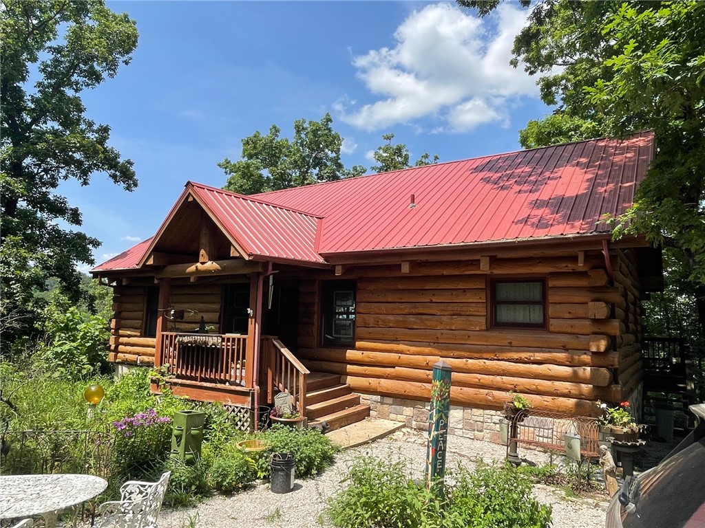 Charming Country Retreat with Modern Comforts!
Welcome to your dream home nestled in the heart of serene countryside living! This beautiful 3-bedroom, 2-bathroom log home sits on 14 acres m/l with mature trees, open skies, and room to breathe.
• Inviting Front Porch – Perfect for morning coffee or evening relaxation with peaceful views.
• Open-Concept Living Area – Bright and airy with large windows, and a cozy fireplace.
• Outdoor Living Space – Includes a large deck and shaded backyard ideal for entertaining, gardening, or simply enjoying nature. Home is constructed with Douglas fir logs and spruce wood for floors
This property offers the perfect blend of rural charm and contemporary updates—ideal for families, retirees, or anyone seeking a peaceful lifestyle without sacrificing modern conveniences. This home offers a back-up generator and solar panels.
Don’t miss your chance to own this unique gem! Located near Table rock lake, Kings River, Eureka Springs