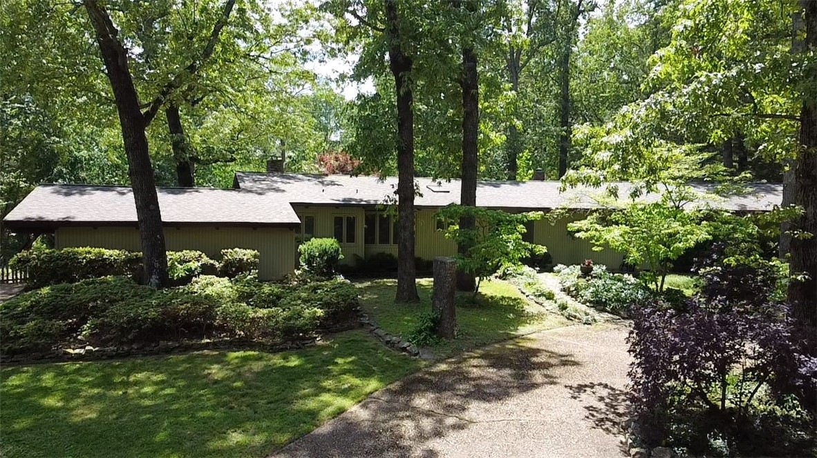 Tucked away in a serene, wooded setting, this stunning 3-bedroom, 3.5-bath home offers the perfect blend of privacy, comfort, and modern rustic charm. Step inside to find a spacious kitchen ideal for gatherings, a separate dining room, and a cozy family room--all designed for relaxed living & entertaining. Enjoy timeless elegance with hardwood floors, exposed wood beam ceilings, and beautiful stone fireplaces that add warmth & character. The fabulous primary suite is a true retreat, featuring a stone wood-burning fireplace, builtin-in closet dresser, and a spa-like bathroom with a walk-in shower. Step through sliding glass doors to your private deck--perfect for morning coffee. You will love the seclusion of the backyard from the covered deck, to the open decks, stone walkways the enjoy the outdoor stone fire pit and the inground pool. For you enjoyment whether is it with your friends & family or your own private get-away.