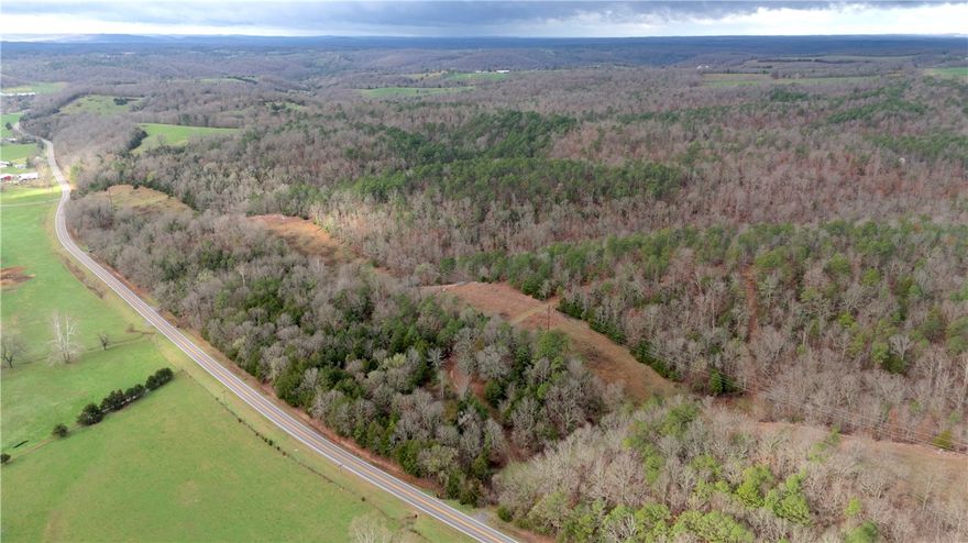 Located in the Ozarks of Carroll County, Arkansas, this 58.5± acre tract offers a great blend of country living, hunting potential, and convenience. About 7 miles north of Hwy 412, the property provides privacy while remaining easy to access. The land features a healthy mix of mature hardwoods and evergreens, keeping the property scenic year-round. Rolling terrain offers potential eastern views with selective clearing—an ideal place to watch the sunrise over the Ozark Mountains.

A strong ridge system with drainages and natural pinch points creates excellent wildlife travel corridors, with a history of solid whitetail harvests and recent trail-camera activity. Access comes from the east off Hwy 21 via rough-cut roads leading to two potential building sites. A pond surrounded by mature pines provides a peaceful setting for a cabin or home. Three-phase power runs along the paved road. Convenient to Kingston, Huntsville, Berryville, Harrison, and Branson.