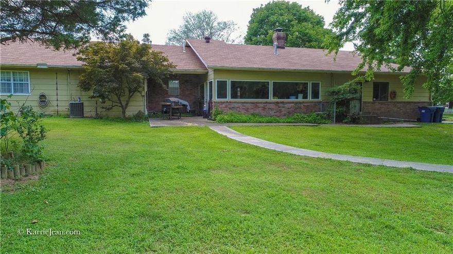Spacious 2 bedroom with office and enclosed patio with gorgeous views of 2+ acres! This could also be a 3rd bedroom. Master bedroom has separate entrance. Double sinks in the 2nd bathroom including a walk in shower. Two living areas, gas log fireplace, formal dining. Large 3200 SF detached shop/RV storage with additional parking,attached and detached garages. Zoned R-O! A must see country feel less than 1 mile off I-49!