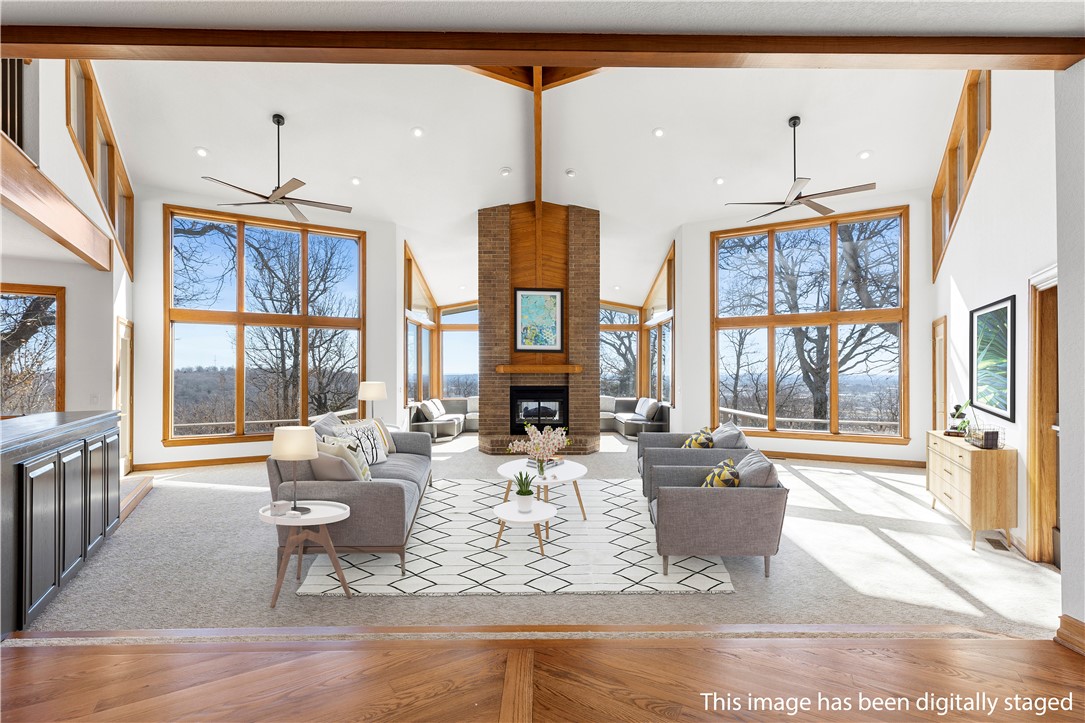 Welcome home to this stunning, newly remodeled one owner estate in Springdale's highly coveted Woodcliff S/D. Situated between historic downtown Springdale & Beaver Lake, this home was designed by renowned architect Albert Skiles. This home maximizes views from every angle going beyond the 3.25 acres it sits on. An entertainers dream, this home flows seamlessly from the expansive living room to the 2,000+sq.ft. deck. Beautiful dining room, kitchen & hearth room allow for multiple entertaining spaces downstairs. A primary suite boasting two luxury bathrooms, two walk in closets & expansive sun porch all make this a homeowners dream. A guest bedroom, library/office, expansive laundry room, powder bath & second sunroom also reside on the first floor. Upstairs you will find two bedrooms and full baths, one bedroom boasts a study room with built in desks. A members only pool, clubhouse, tennis court are an added bonus to enjoy with guests. This estate is truly a must see home so schedule your tour today!