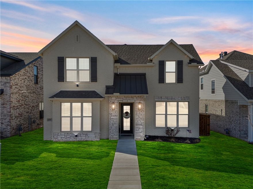 Nestled in Bentonville’s highly sought-after Aurora community, this thoughtfully designed home offers access to one of the area’s most desirable neighborhoods featuring resort-style amenities including an adult-only pool, family pool, clubhouse, playground, pickleball court, and dog park. The open-concept living, dining, and kitchen areas create an easy flow for everyday living, with a large island, pantry, and engineered hardwood floors throughout the main level. French doors lead to a covered patio with an outdoor gas fireplace overlooking a backyard upgraded with $20,000 in professional artificial turf. The primary suite is located on the main floor with dual closets, a soaking tub, walk-in shower, and double vanity, while two additional bedrooms and a shared bath are upstairs. Like-new, well-maintained. Preferred lender offering up to $3,000 in credits for qualified buyers.