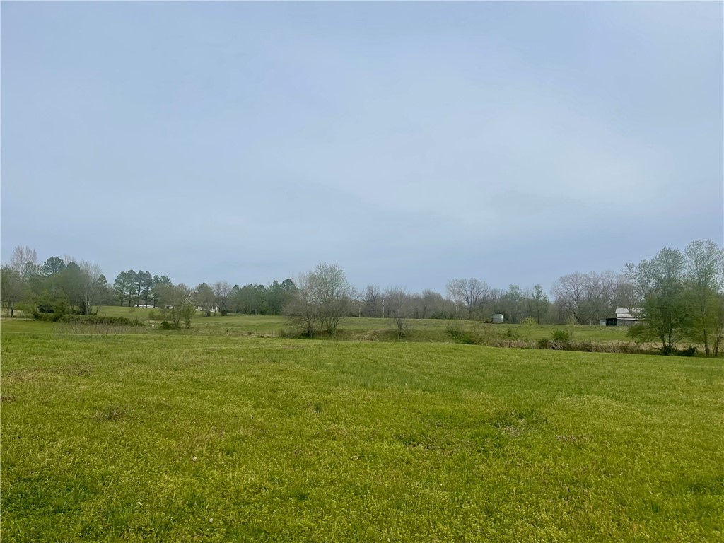 10 Beautiful Acres to build your dream home with a spring that runs the year round. Property would be perfect for a family compound with multiple building sites available.This property is close to everything NWA has to offer. Existing older home has termite damage, but property is perfect. A must see!!!