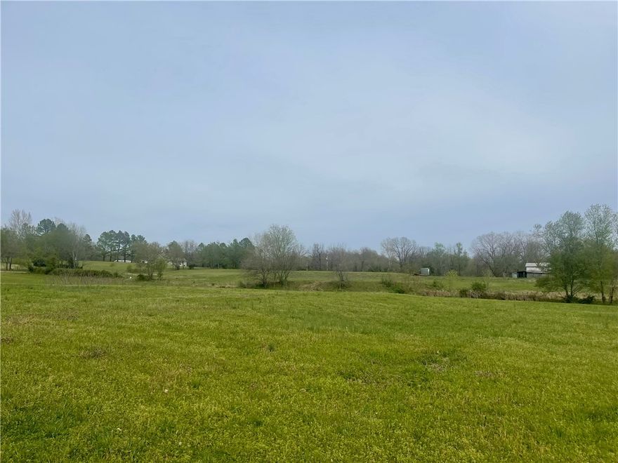 10 Beautiful Acres to build your dream home with a spring that runs the year round. Property would be perfect for a family compound with multiple building sites available.This property is close to everything NWA has to offer. Existing older home has termite damage, but property is perfect. A must see!!!