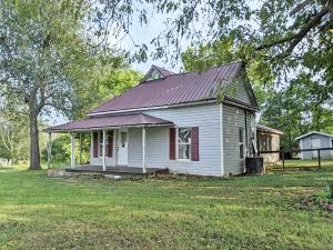 Cute farm house with covered porch, detached garage/shop, storage building, all on near level lot on paved road approx 1 mile outside of Western Grove. Selling as-is. All #'s are approx, age is estimate, sq footage per assessor. Buyer to verify existence of septic.