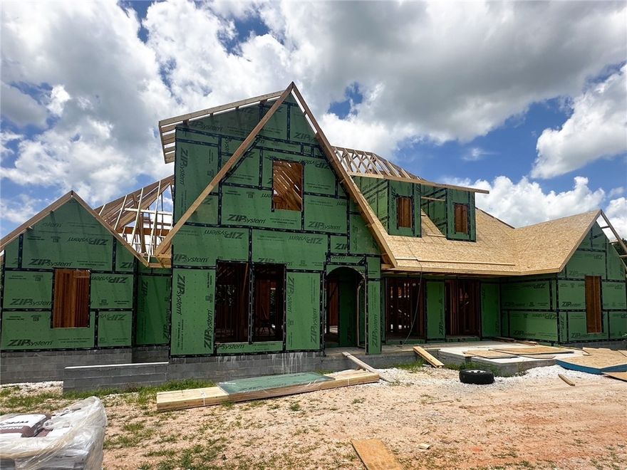 This new 5-bedroom, 4-bath home in Blackberry Ridge was designed by Lane Crosno Designs. The entry opens to a spacious living area with a raised ceiling, fireplace, and French doors leading to the covered back porch. The kitchen features a large island, quartz countertops, Café appliances, and a walk-in pantry. The dining room sits just off the entry and opens to a front courtyard, adding a unique indoor-outdoor element. The main-level owner’s suite offers a vaulted ceiling, walk-in closet, and a spa-like bath with a freestanding tub, walk-in shower, and dual vanities. A second bedroom or office, full bath, laundry room, and mudroom complete the first floor. Upstairs are three additional bedrooms with vaulted ceilings, two full baths, and a bonus area. The home also includes a three-car garage prewired for an EV charger. It is located near the neighborhood pool and pavilion. *Agent Owned*