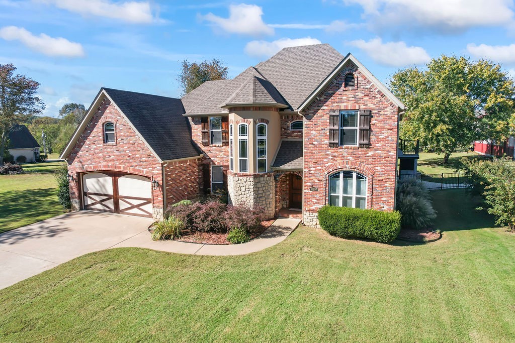 Gorgeous 4 bedroom home 2 1/2 bath home with private boat slip which includes a 7000# lift and swim deck within very easy distance from home. Priced Below Appraisal! New Heat pumps and A/C units. Central Vac On-Demand Hot water. Granite countertops and knotty alder kitchen cabinets. Master is on main floor. 2 sided gas fireplace between master bath and master bedroom. Beautiful sun room addition with walls of windows with relaxing hot tub. New roof in 2020. The garage is heated and cooled and this is where the F-5 rated safe room/tornado room is located. $175 annual dock fee