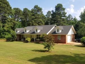 This is a lovely contemporary home in a beautiful secluded location with tons of privacy. Set far back off the road behind the pines lies this 3 bed 2 bath with a giant yard on 3 acres m/l. Inside is a cathedral ceiling with track lighting, a wood stove, very nice wood floors and a large eat-in kitchen. French doors lead to a big back deck, freshly stained, overlooking the huge back yard completely surrounded by woods for peace and quiet. The over-sized 2 car garage has a corner nook that serves as a great man-cave and a stone path leads to the beautiful front porch. A very nice bonus: a brand new roof was put on in 2017. A home this attractive in this kind of location is not to be missed. Call to see it today!