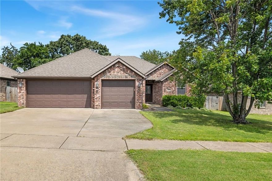 Welcome to this comfortable and spacious 3 bed, 2 bath fully brick home tucked away on a quiet street. A formal dining room sits just off the entry, while the open main area features an electric fireplace in the living room and an eat-in kitchen with granite countertops and a dedicated pantry. The generously-sized primary suite includes a walk-in closet and a large en suite bath with dual vanities, a jetted tub, separate shower, linen closet, and private water closet. Two spacious secondary bedrooms are located on the opposite side of the home, with a full bath in between. Step outside to enjoy the covered patio and fenced backyard with peaceful views of open green space and trees. A 3-car garage provides ample parking and storage. Conveniently located near trails, parks, schools, the U of A, Hwy 112, and I-49. Brand new HVAC installed June 2025, and new carpet was installed earlier this year.