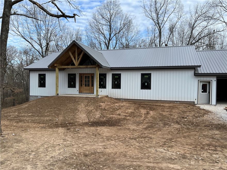 Brand New Construction!!  This 2,152 SQFT modern farmhouse-style home features 3 BR-2 BA, "fantasy brown" granite kitchen countertops, cathedral ceilings, luxury vinyl plank flooring, oversized 2 car garage (25' x 34'),  covered porches, and board and batten siding.  Home sits on a corner lot with 0.76 ac m/l, large trees, asphalt driveway, public water, and paved roads. 8 minutes to Wal-Mart in Harrison. 25 minutes to Branson, MO. Approximate completion date is mid-May.