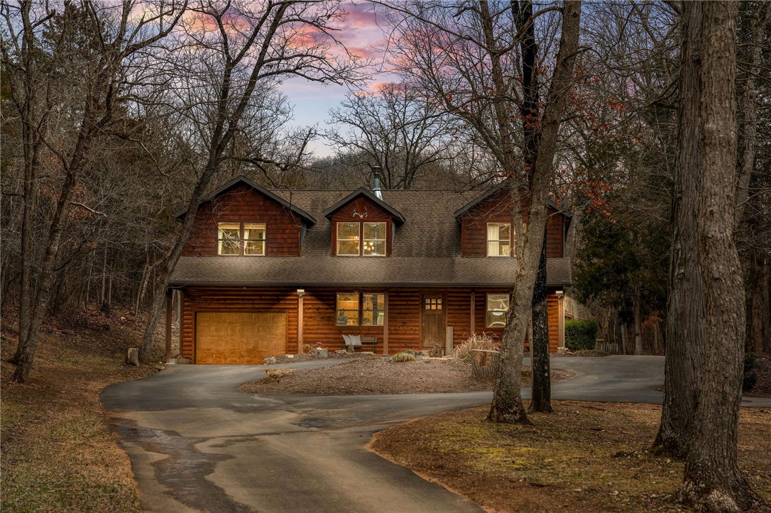 The Ultimate Ozark Mountain Retreat! This 15-acre private estate offers the perfect blend of seclusion and adventure. Located just 15 minutes from Big Cedar and 20 minutes from the Branson Strip, you can enjoy the area's most popular attractions and return home to relax by your private creek. Features include a basketball court with lights (set up for pickleball), a shooting range, and a private dirt bike course. Plenty of space for your toys with an attached garage and a detached shop. Table Rock Lake is just across the road, and a slip lease is available at Cricket Creek Marina. No vacation rental restrictions allow for income opportunities while maintaining conventional financing eligibility. Whole-house generator and wood stove included for year-round peace of mind