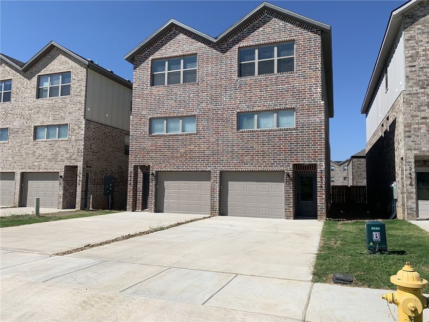 Enjoy an amazing location directly across from the newly remodeled Osage Park, Lake Bentonville, and Bentonville Airport (private planes only). This home offers quick access to Climb Bentonville, Bentonville Brewing, Walmart HQ within 10 minutes, and Bentonville Square in under 15 minutes. The second level features an open living room with great natural light and modern fixtures, along with a kitchen offering stainless steel appliances, white cabinets, and quartz countertops. The primary bath includes a walk-in shower and double vanity. The third floor offers two guest bedrooms, a full bath, small office space, and a large storage room. The main level includes a tandem two-car garage, extra storage, and access to a fenced backyard with patio.**FIREPLACE DOES NOT WORK - $50 PET RENT PER PET - $350 NON-REFUNDABLE PER PET**