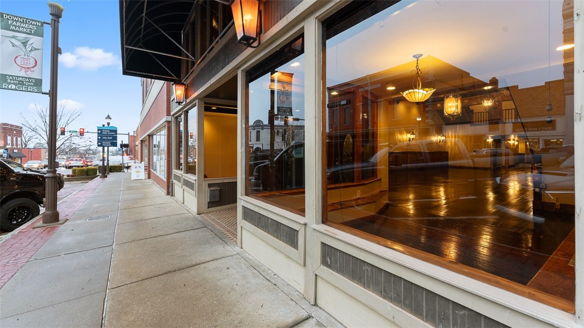 Located in the Historic Downtown Rogers Entertainment district offers a unique and engaging atmosphere and is walkable to outdoor gatherings, concerts, and shopping. Originally a local favorite farm & supply store & several businesses offering services such as doctor offices, funeral home, hardware & automotive, restaurants, and event venues most prominently The Grand at 117. When visiting - Park on the brick streets and enter through the old-time storefront into a great room w/ high ceiling, iron chandeliers and views of the grand staircases & mezzanine balcony overlooking the venue. As a restaurant, it has a full-size commercial kitchen, hood vent system, 2 walk-in coolers & a Glycol tap system for the first & second-floor bars. Add'l storage in full-height basement. Newer HVAC units & new roof 2024. Ambient outdoor patio seating. Add'l municipal parking behind the building with Rogers' alley lightscapes. Near Railyard Park, Butterfield Stage, and APT in the heart of Rogers Entertainment District.