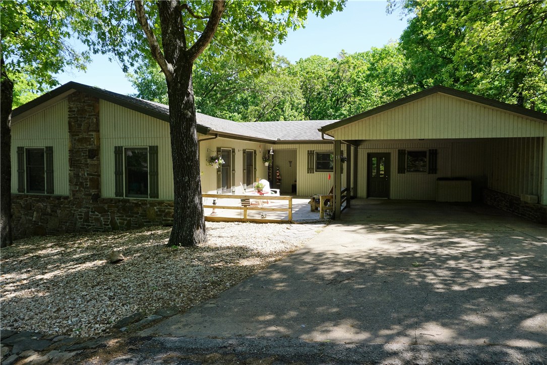 Put this on your list to see! Convenient to Highway 71, Spacious one level home in great location (close to 2 golf courses & Riordan Hall (playground, pool, tennis, recreation hall & exercise room). Beautiful native stone & siding exterior. Maintenance free rock yard in front, slightly sloped and grass in back. 2 car Carport could easily convert to garage. 4 bedrooms, sunroom; lovely native stone fireplace in living room. Quiet neighborhood! Great price for the square footage! Workshop under house.