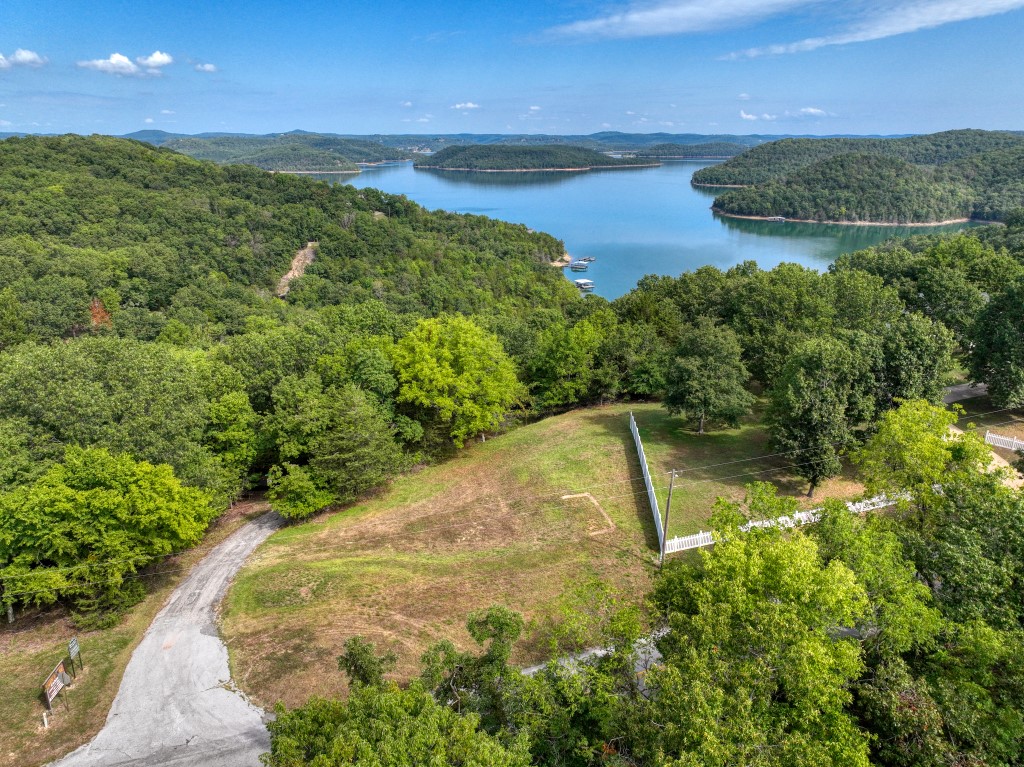 Build a house with a wintertime lake view and become part of the Grassy Knob community! Compared to most lots, this excellent lot is almost flat! Because it is located in the Mundell Heights Estates subdivision, you can connect to the community water system and there is no need to drill an expensive well! This low-slope lot with itās community water system connection, will substantially reduce your building costs. Access is all on paved roads and Starkey Marina is very close-by!