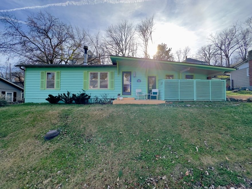 Funky chic 1960s home in the heart of Eureka Springs! Easy access to historic downtown shops, dining & culture. Features hardwood floors, two-sided gas fireplace, lanai, private back patio and rare off-street parking. Move-in ready!