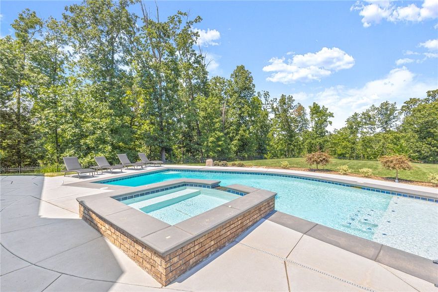 Oak Tree Estate home on 1.39ac lot, newly added pool & outdoor living space, 5 Beds plus bonus space, home office & more! Spacious driveway & Foyer entry welcomes you. Formal dining w/ accent wall. Living room has fireplace w/ built ins, large windows looking out to your private yard & wooded setting, wood floors, and open to kitchen. Kitchen has beautiful coordinating granite counters & backsplash, large island w/counter seating, 6 burner gas range w/ pot-filler & large pantry. Home office w/full wall-built ins. Guest suite w/attached bath & WIC on main. Primary suite is a spacious bedroom w/sitting area, spa-like bath has gorgeous soaking tub w/ wraparound walk in shower! Downstairs is the second living area. 1 guest room has attached bath. 2 additional guest rooms share jack & jill bath. Access to the large, covered patio on lower-level w/built in radiant heaters, outdoor kitchen & great seating space. Heated saltwater gunite pool w/tanning shelf & built in hot tub. Safe room. Gated community w/great amenities!