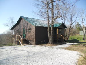 Newer 2BR 2BA cabin with 23.20 acres joining the National Forest on 3 sides. Home features hardwood floors throughout, tongue and grooved pine on the walls and ceilings, central heat and air, wood burning fireplace, 8x32 covered back porch overlooking the head waters of Big Creek. House was built to be maintenance free, hardy board siding, metal roof, foam insulation. Comes with 30x50 shop with 12 foot side walls, concrete floor, and 2 roll up doors. Great garden spot with extra well for watering, large pond stocked with catfish and bass, multiple trails on the property leading to the National Forest. This is a rare opportunity for someone, hard to find all this on a quiet paved road in the middle of the National Forest.