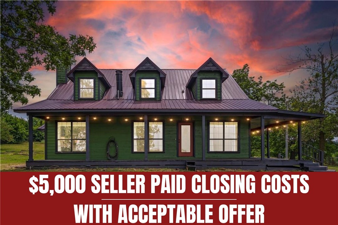 Enjoy the best of both worlds with this unique 3-story craftsman-style home on 2.11 acresāpeaceful and private, yet just minutes from town. Wake up to stunning sunrises and sip your morning coffee while taking in the rolling mountain views from the semi wraparound covered porch. The exterior features freshly painted cedar siding, a newer metal roof, and metal fencing. Inside, you'll find cathedral ceilings, tall windows for natural light, and a double-sided wood-burning fireplace connecting the living room and ownerās suite. The eat-in kitchen includes a pantry and electric appliances. The main-level primary suite boasts a soaking tub, walk-in shower, and dual marble vanity. Upstairs offers two bedrooms with new carpet and a full bath. The finished walk-out basement features a bonus room with new carpet, full bath with Razorback sink, laundry with utility sink, and an extended garage. SELLER OFFERING UP TO $4,000 CREDIT TOWARD LENDER PREPAID ITEMS. $5,000 SELLER PAID CLOSING COSTS.