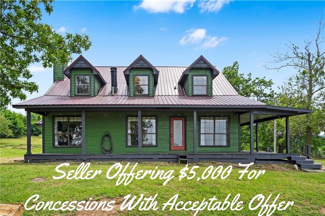 Full of charm and surrounded by nature, this 3-story craftsman sits on 2.11 acres with mature trees, privacy, and rolling mountain views. Enjoy sunrises and sunsets from the semi wraparound covered porch. Exterior features include freshly painted cedar siding, a newer metal roof, and metal fencing. Inside, cathedral ceilings, tall windows, and a double-sided wood-burning fireplace connect the living room and primary suite. The main-level primary offers a soaking tub, walk-in shower, and dual marble vanity. An eat-in kitchen includes pantry and electric appliances. Upstairs features 2 bedrooms with full bath, while the finished walk-out basement offers a bonus room, Razorback sink bath, laundry with utility sink, and extended garage. With updates already completed plus opportunities for remodels and creative projects, this home is perfect for those seeking a peaceful setting just minutes from town. $5,000 preferred lender credit.