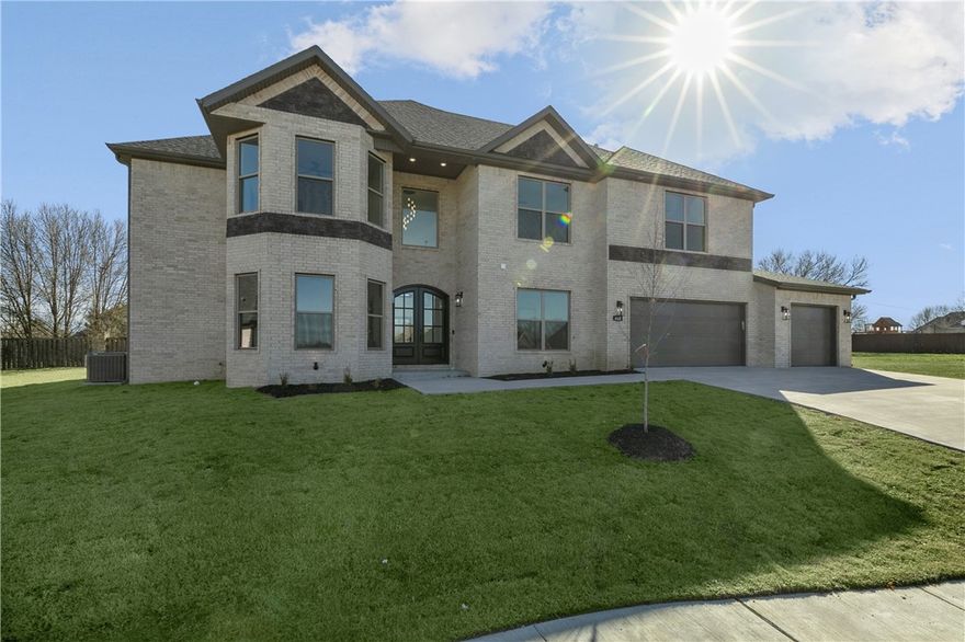 Welcome to your next home! Upon entry, you will be amazed by the 20' high ceilings, designer lighting,  wall of windows, & a floor-to-ceiling custom-detailed fireplace. The kitchen lends itself to entertainment with a 10' island w/storage & easy access to the large covered patio. Features include custom-designed cabinets, quartz counters, & a spacious walk-in pantry. On the main level, the Owner's Retreat is the perfect place to escape when you desire peace & quiet w/a a soaking tub, and a fully tiled shower w/ hand wand, body massage jets, & rain shower head for a luxury spa experience. The closet features a pass-through to the laundry/utility room. Main level study. Head upstairs to find a loft area, a second ensuite, two secondary bedrooms & a home cinema with bar. Oak Tree has a community resort-style pool, tennis courts, fitness center, playground, & basketball courts. Close to Gamble Elementary & Bentonville West High School. There is so much to love in this one; make sure its on your short list and come see!