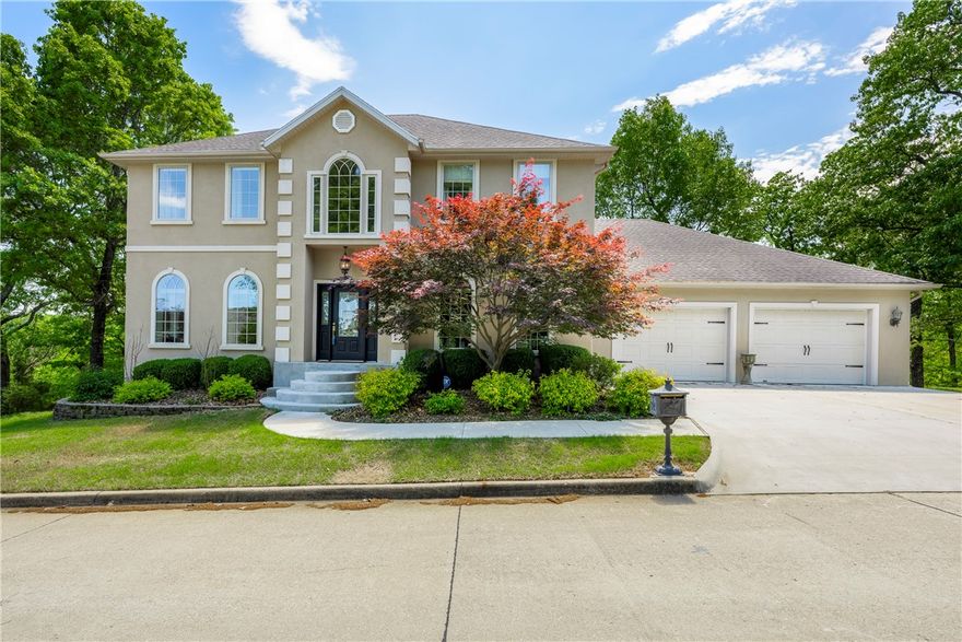 Step into luxury w this executive home located in the coveted Serenity Point on Beaver Lake. This stunning property features 5 bdrms, 3 full BA & 2 half BA, offering ample space for comfortable living. The walk-out basement is complete w a wet bar, living room, laundry/storage, the perfect entertainment space. The main level ft. stunning wood floors, the living room boasts high ceilings, ample natural light, open to the kitchen & dining area. The kitchen is a chef’s dream w/double ovens, gas cooktop, ample cabinets, island, bar seating & breakfast nook. The primary bdrm is accessibly located on the main level w/a seating area & fireplace & private bath, 4 secondary bedrooms are located on the second level w/two jack & jills, all bedrooms have wood floors. Outside you’ll find a spacious deck overlooking the 1-acre lot, as well as a patio off the basement w/hot tub. Just a short walk or ride (Gator included) to the shared dock w private 24x8 slip/lift next to swim deck.