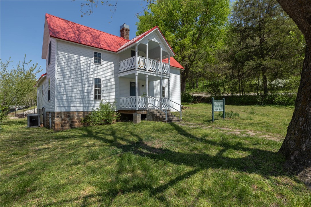 Bessie's Inn; where history and modern come together. Located just off the charming Huntsville square, this depression era homestead was stripped to its bare bones and given new life in 2020. In addition to fully rehabbing the existing structure, the floorplan was extended creating 2429 sqft. Serving as a short term rental, Bessie's Inn, comes TURNKEY & boasts 4 large bedrooms, 2 living rooms, a huge kitchen & 1 bathroom on each level. With ceramic wood floor tile downstairs and LVP up, there isn't an inch of carpet. The kitchen has like new stainless appliances and beautiful granite.The bathroom has a restored antique clawfoot soaker tub, tile shower & granite vanity. 2 large rooms and a living room round off the 1st level. Upstairs, you'll find 2 more large bedrooms, second living room/parlor & a full bathroom with tile shower and dual granite vanity. Metal roof,2-level covered porch and balcony. Walk to the boutiques on the square, Harps for groceries or Granny's for home cooking. Cross Listed as MLS 1305063.