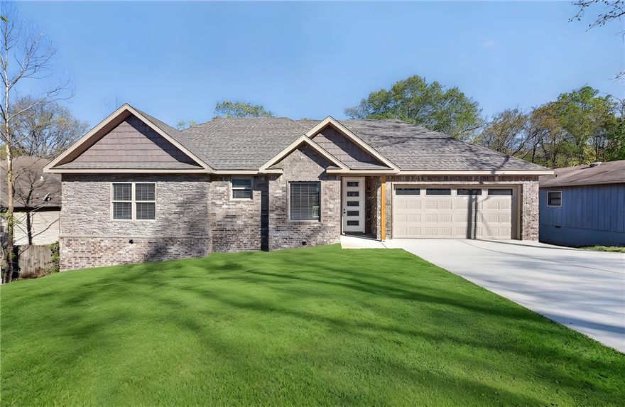 Welcome to this brand new 2 bedroom, 2 bathroom home located in the heart of Bella Vista. Designed with comfort and functionality in mind, this new construction features an open-concept floor plan with luxury vinyl plank flooring and a bright, modern color palette. The living room offers a cozy gas fireplace and flows seamlessly into the kitchen and dining area—ideal for entertaining or everyday living. The kitchen includes stylish cabinetry, stainless steel appliances, and a large island with bar seating. The primary suite features a private bath and walk-in closet, while the secondary bedroom is perfect for guests or a home office. Enjoy the peaceful wooded setting from the back deck. Additional highlights include a 2-car garage, energy-efficient construction, recessed lighting, and low-maintenance exterior. Convenient to Bella Vista’s golf courses, lakes, trails, and amenities.