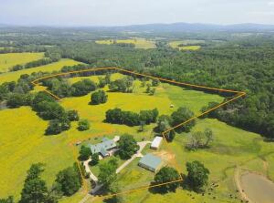 A gently rolling drive across the beautiful pasture ends inside the fenced lot of the home and shop buildings.  Parking, equipment storage, space for pets, livestock, toys, friends or family won't be a problem with the circle drive, huge shop buildings, 2 carports, and even horse stalls. The home boasts a large kitchen with double ovens, and all 5 bedrooms on the lower level. There is an enormous master bath suite, and a large outdoor patio for entertaining or relaxing. Upstairs has two large dens and another full bath, creating potential for a 6th bedroom. There is also a dedicated office on the main level. The easternmost shop is approximately 30 x 75, with electric roll up doors.  This shop is mostly concrete floored, but also has partial dirt floor for the two horse stalls