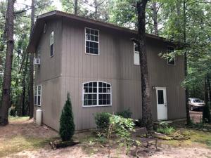 LOOKIN FOR WOODED PRIVACY? This is a 2 story cutie with 3 bedrooms 1 1/2 bath. Full bath upstairs. Half is downstairs but has enough space to add a shower or tub. Mainly lacking some trim. Seller is leaving materials such as doors and trim. Also leaving refrigerator, cook stove, heat stoves, window ac, new kitchen countertop and sink, washer, dryer and some furniture. Two outbuildings for storage and a playhouse. Includes two 1.25 acre lots for 2.50 total wooded acres. Window air and space heat. House is easy to heat and cool. City water. NEWER energy efficient windows, doors and metal roof. Skylight.