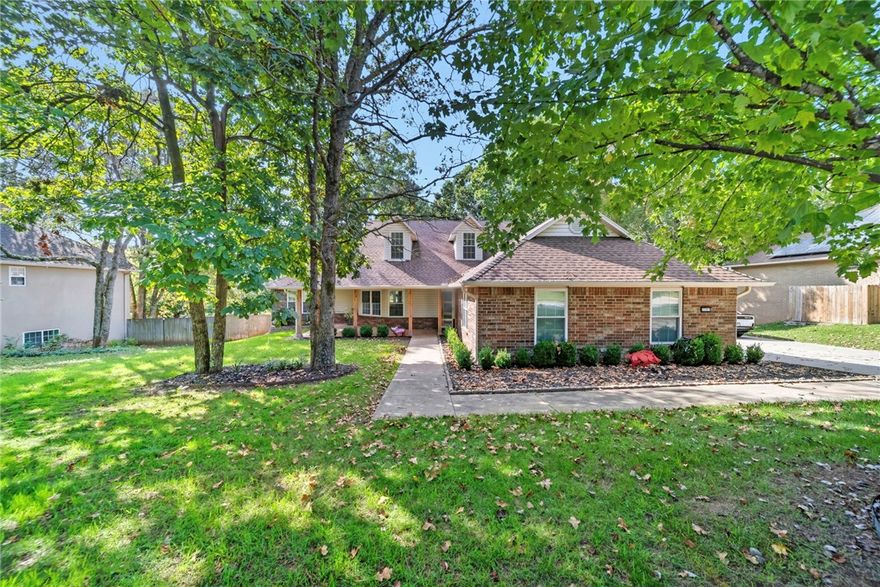 This stunning two-story home has been nearly fully remodeled, offering a bright, open layout filled with natural light. The living room features custom built-ins and a cozy fireplace, while the kitchen impresses with white quartz countertops, high-end appliances, and plenty of storage. A sunroom just off the kitchen provides the perfect spot for morning coffee or relaxation. The main-floor primary suite includes two spacious walk-in closets and a freshly remodeled spa-like bathroom. Upstairs are two large bedrooms and another full bath. Outside, enjoy a 1,300 sq ft cedar deck with an outdoor kitchen setup, lighting throughout, a pergola, and a hot tub that conveys. The property is wired for high-speed internet that extends to the deck and the barn, which has been converted into a stylish mancave. A new fence surrounds the expansive backyard, ideal for entertaining, pets, or play. With quality upgrades, modern finishes, and an unbeatable East Fayetteville location, this home is waiting for you!