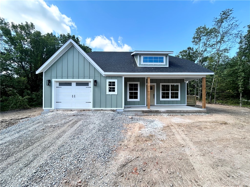 Discover this stunning new cons't craftsman style home located near the Loch Lomond boat launch and provides easy access to Highlands Golf Course, & 1-49. This exquisite home sits on a completely FLAT wooded corner lot and boasts high-end finishes throughout! Step inside to find a stylish open-concept layout, adorned with LVP floors. (no carpet) The focal point of the home is the kitchen, equipped with custom cabinets, a wood hood, luxurious countertops, & a large kitchen island. You'll love cooking with premium black stainless steel appliances, including a gas range. Retreat to the primary bath, where you'll find a spacious walk-in tile shower & double vanity. 2 bedrooms / 2 baths. Plus, take advantage of $3,500 in buyers closing costs, courtesy of the builder's preferred lender! Approx completion date - 9/5/25. This home is eligible for RD financing (no down payment).