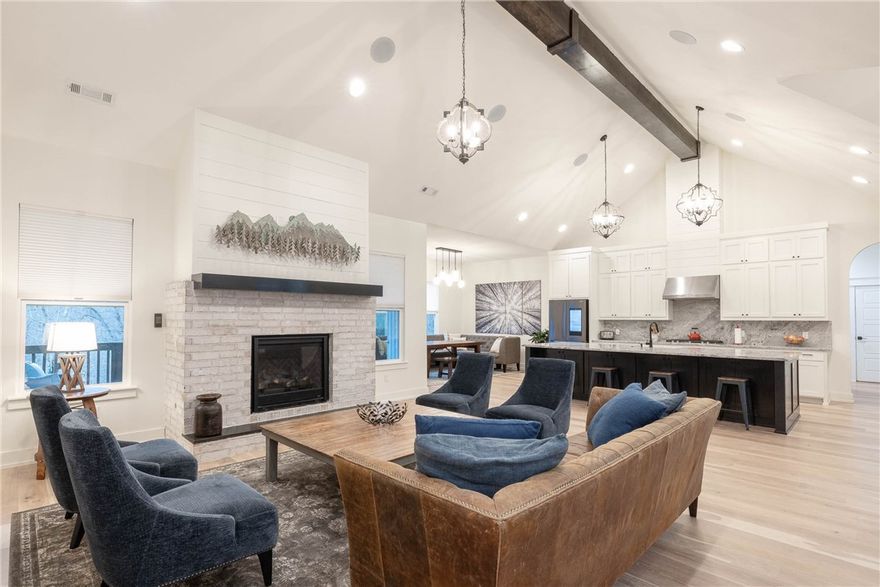 This new home is a dream! 5 bedrooms, an office, a bonus room, 2 living rooms, 4.5 bathrooms, 2 large decks w/ breathtaking views, and a massive 6-car garage, nestled on a wooded 3.66-acre lot. You'll be captivated by the home's stunning interior. The centerpiece is a large living room w/ a beautiful brick fireplace that adds warmth and charm. The expansive kitchen has double ovens and a large island. The luxury primary ensuite has a deluxe bathroom with a large walk-in closet and shower with two shower-heads, and a soak-in tub. There are 2 additional bedrooms on the other side of the main level, ensuring everyone has their own space, and for your guests, an ensuite. The downstairs level has more space to enjoy w/ a bonus room, a 2nd living space, a full bathroom, 5th bedroom, and also an office. The 4 car garage is climate controlled and has a climbing wall, and a workshop. This home is less than 3 miles to the future Bentonville Cycling Center, 5 min to Back 40 and other trails, and 15 min to Bentonville square