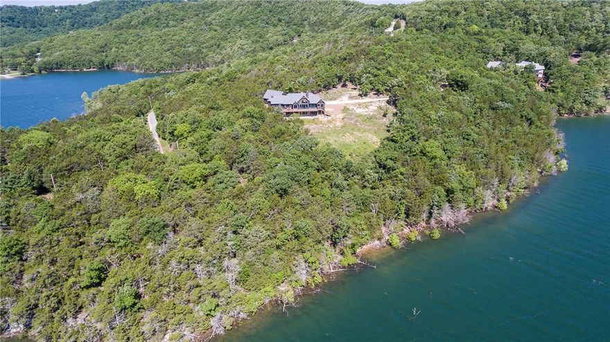 The ultimate in luxury, my 13+ years as a real estate agent, I have never seen a home such as 21919 Pine Log. The pictures speak for themselves. 4 bedrooms, 3.5 baths, one being a campground bathroom. Year round views of Beaver Lake. Years of thought went into this home designed by the owner. Reclaimed wood flooring from Missouri, beams from the old Berryville bridge concrete siding, 3 car garage with 14' ceilings. Please see attachment of amenities. Wall mount commodes. All appliances stay,