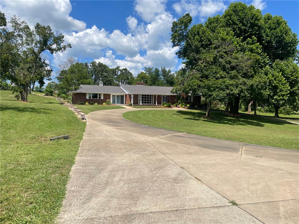 2331 Sq. foot Ranch Style Brick Home with 3 bedrooms and 2 bathrooms. Two Fire places, Formal Dining room, Bonus Room and a partial basement area with a Storm Shelter. Some upgrades have been made along with some new appliances. One Fire place is Gas Logs and the other is wood burning. Landscaped yard along with views. This Home features an in ground Pool that is ready to enjoy and go out and set by the Running water Fish Pond. 1 acre m/l will convey with Home. A new survey will be provided by seller. This property is part of Carroll County, Arkansas parcel # 001-06483-000 Great opportunity to purchase this Homestead along Hwy 62. Located close to Town and Wal Mart.
